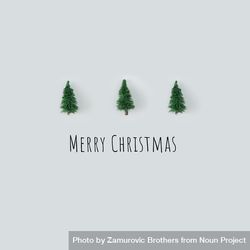 Row of Christmas trees on gray background with “Merry Christmas” 42egq5