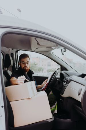 Courier preparing cartons for express delivery