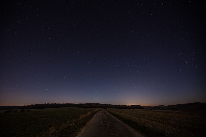 Country road on dark starry night
