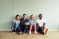 Multi-ethnic colleagues sitting on the floor at work