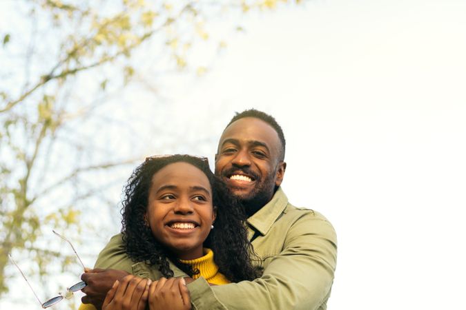 Black couple smiling and hugging
