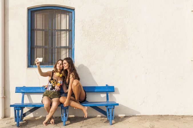 Girlfriends sitting on bench