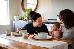 Happy women with baby at their dining table