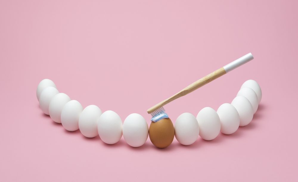 Brushing teeth with a wooden toothbrush