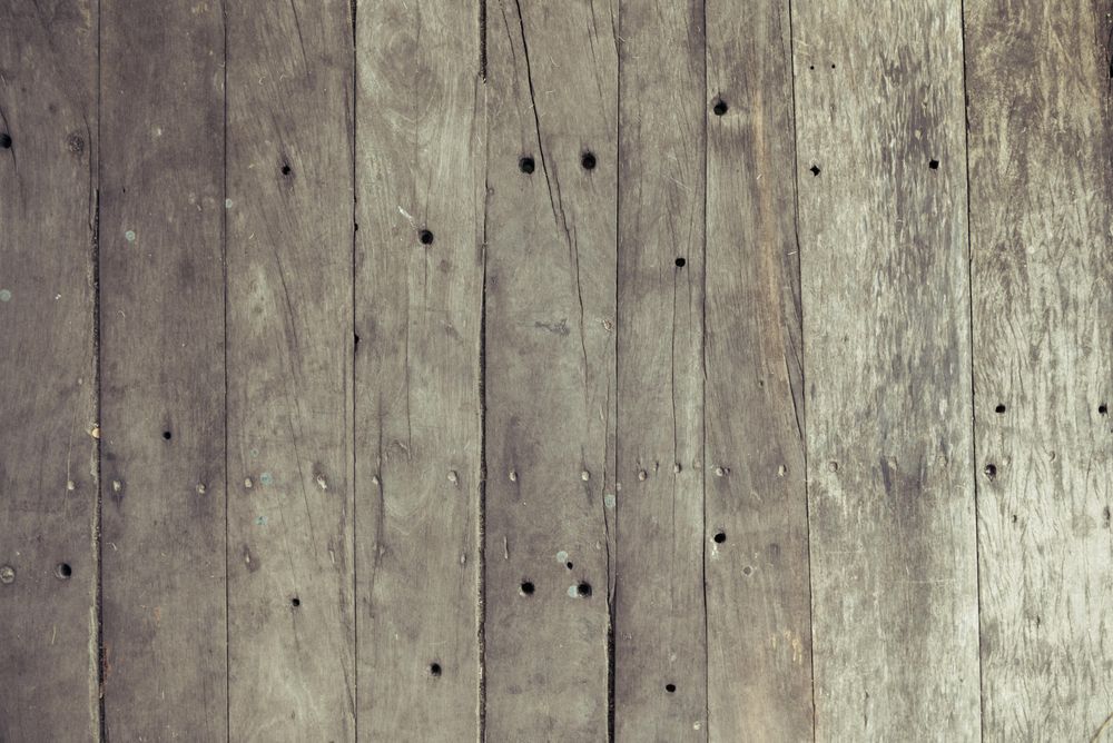Rustic brown wooden board floor with nails