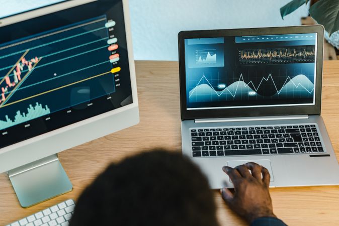 Crop Black businessman typing on laptop