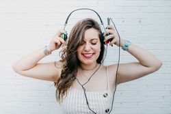 Woman in bright headphones listening to music