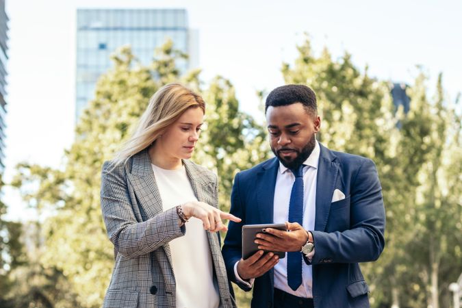 Coworkers talking about business outdoors