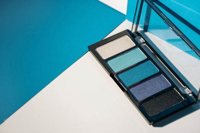 soft blue eyeshadow palette on geometric background.