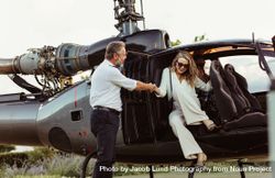 Wealthy woman traveling by her helicopter 0WOEZx