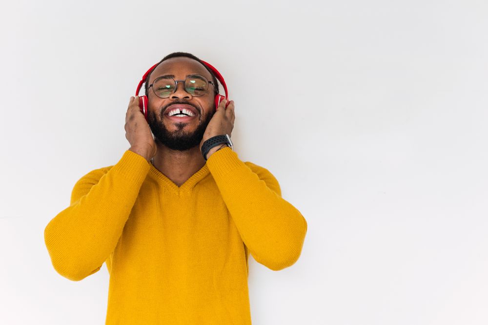 Black man listening to music in headphones