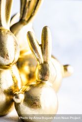 Easter holiday card concept with close up of golden rabbit figurines 0LdNJX
