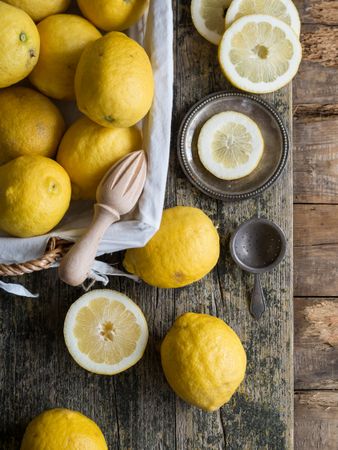 Lemons and reamer placed on wooden board