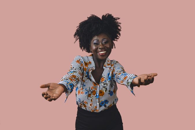 Portrait of happy Black woman with her arms reaching towards the camera
