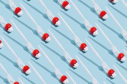 Pattern of forks holding strawberries