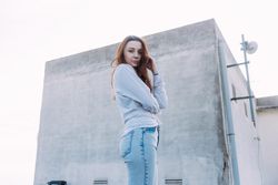 Portrait of red haired woman outside on roof