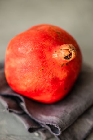 Whole pomegranate on kitchen towel