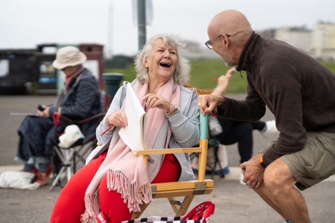 Woman laughing with instructor during art class
