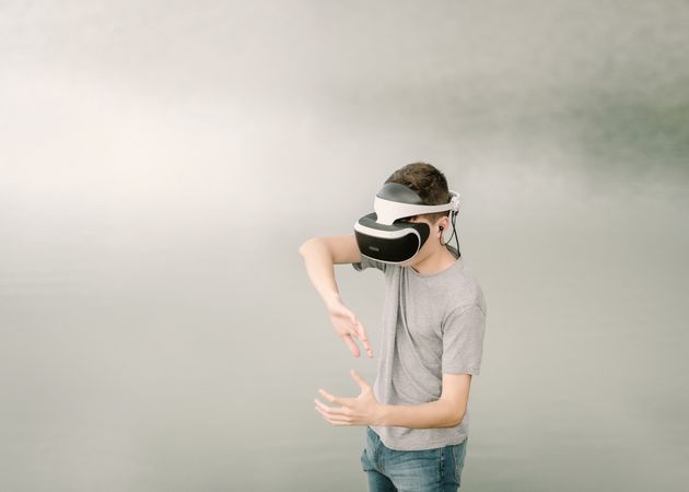 Young teenager with virtual reality glasses outdoors