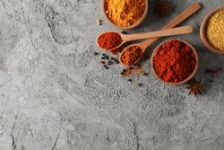 Wooden bowls with red, yellow and brown spices, with copy space