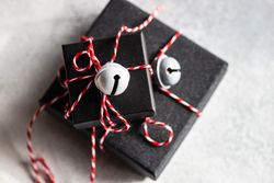 Holiday gift boxes with decorative bells on stone background with copy space