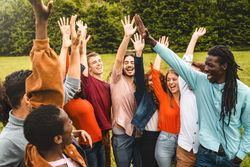 Multi-ethnic friends celebrating outdoors in park