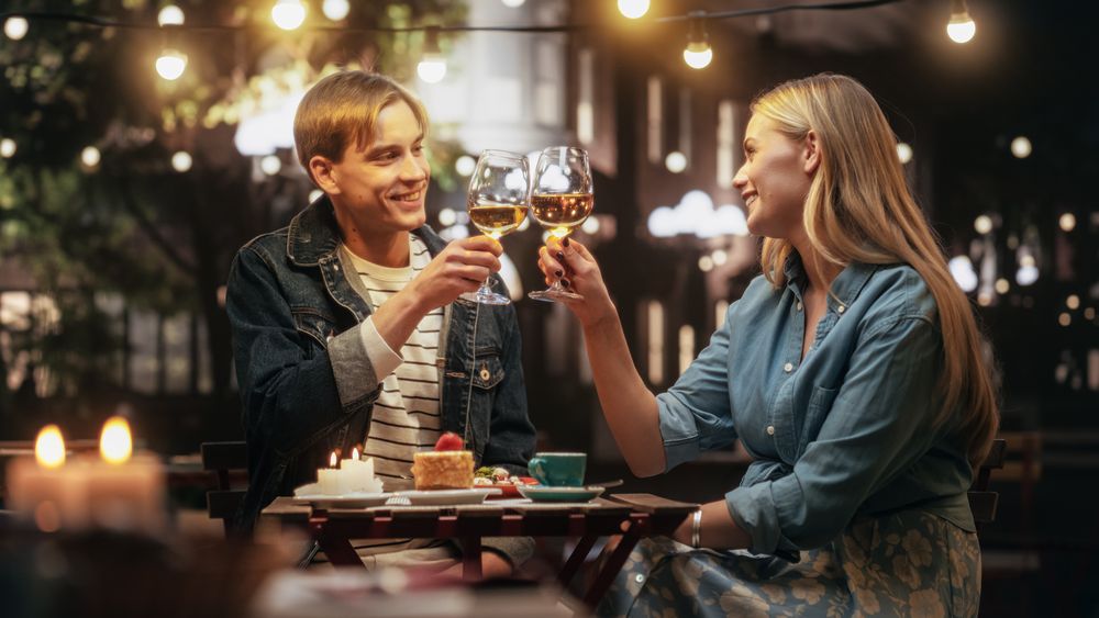 Young Man and Woman Having an Evening Date on a Terrace.