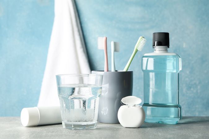 Tools for dental care on blue background, close up