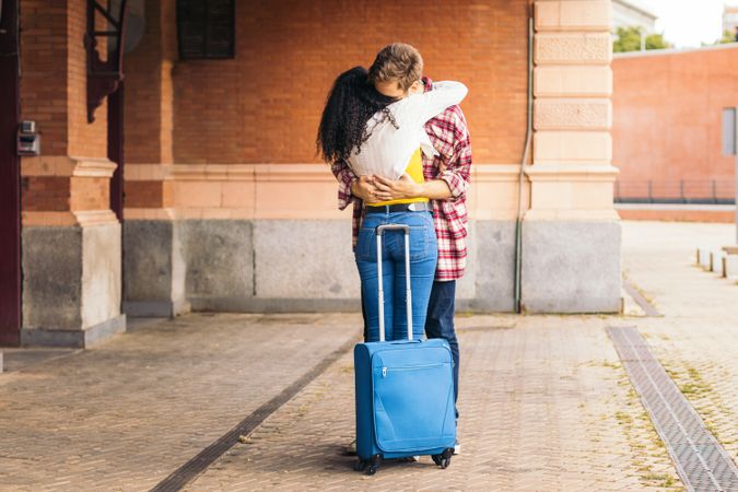 Cute young couple meeting at the station after a trip