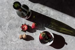 Strawberries near bottle of drink