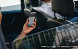 Female using phone during a commuting in a cab 5rxyZb
