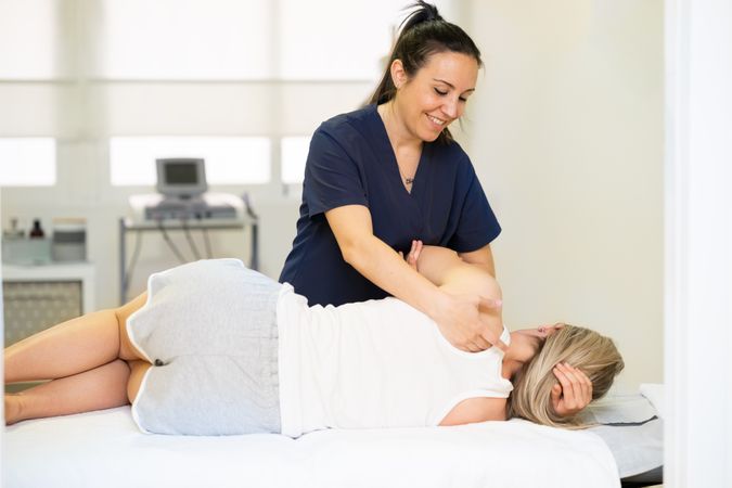Physio working on her client’s shoulder