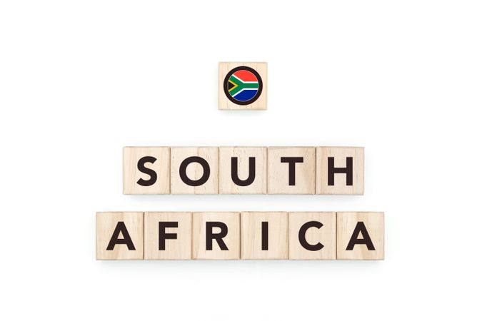 Wooden blocks bearing the name and flag of South Africa. South African Culture, national identity, travel, and geography in a copy space design.