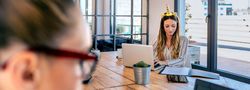 Businesswoman with unicorn headband working