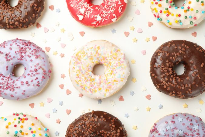 Flat lay with tasty donuts on plain background