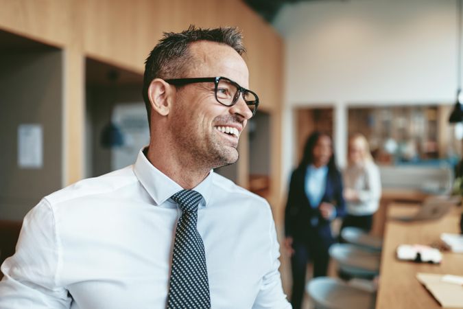 Man in glasses smiling in office