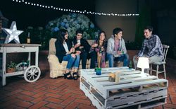 Group of friends drinking and having fun in a party outside