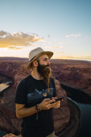 Traveler on the mobile phone near canyon