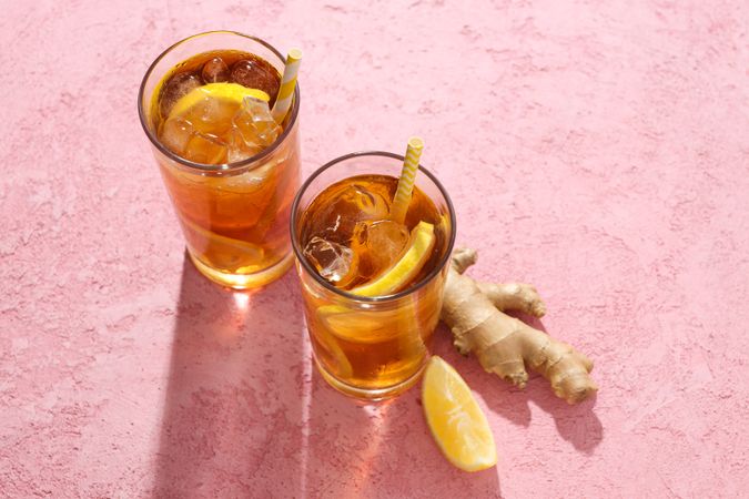 Cold tea with ice, orange slices and mint leaves and ginger