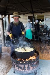 An Amishman tends to popcorn, prepared over an open fire, Berlin, Ohio K4jJx4