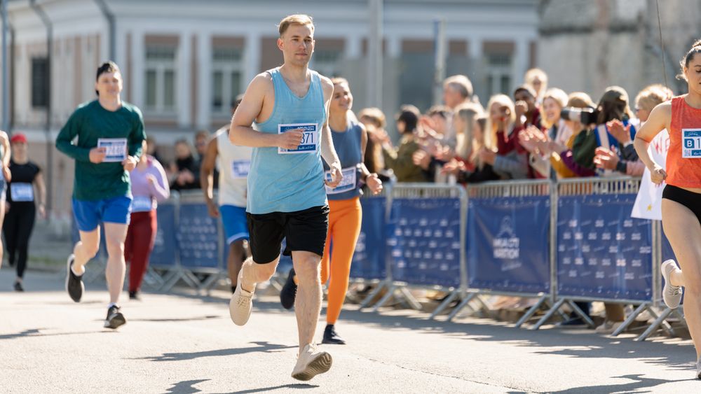 Happy Group of People Participating in a City Marathon.