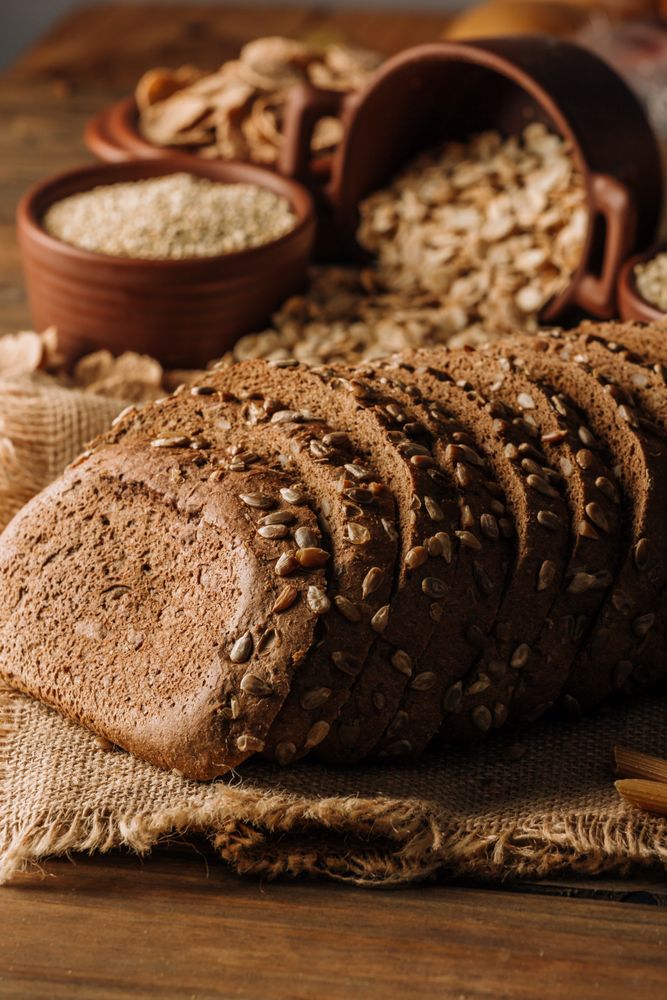 Freshly baked rye bread on napkin on table