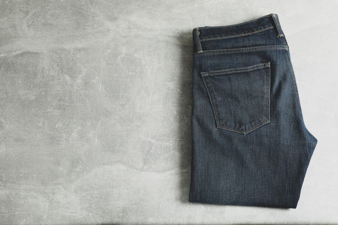 Classic jeans on grey background, space for text