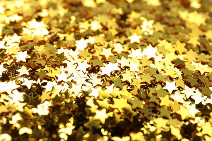 Golden star glitter on whole background, close up