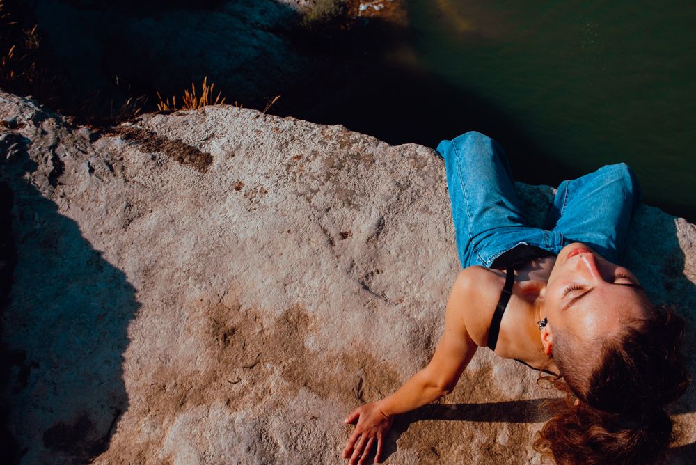 Young woman relaxing on rock