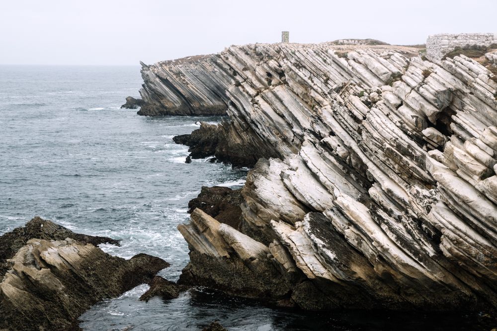 Rocky formations in the island of Baleal on the Atlantic coast in a foggy day. Peniche, Portugal