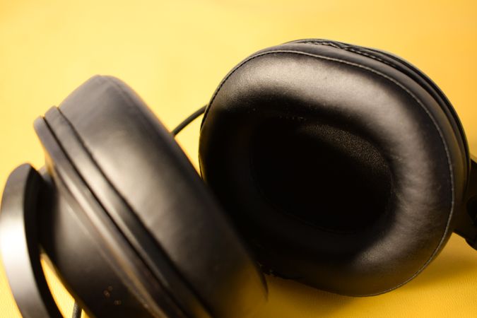 Headphones ear cushions on yellow table