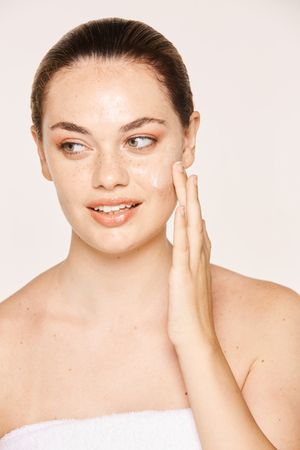 Amiable female taking care of face