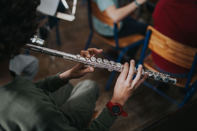 Top view of student playing the flute