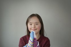 Young child smiling and playing with socks